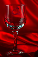 View of a lone glass of wine with a red heart