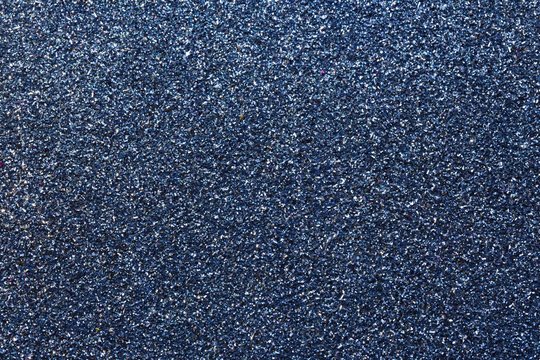glitter on the glittery dark blue background ideal as a backdrop