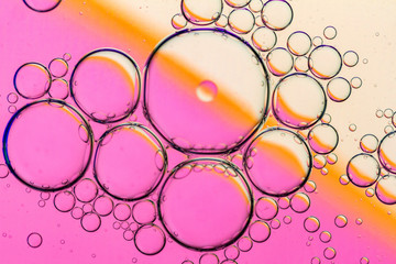 Abstract Background of Oil Bubbles on Water Surface pink salmon colorful palette.