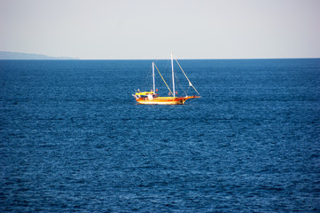 Calm blue sea and a small boat.