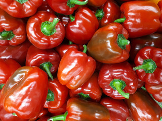 Sweet red peppers background. Paprika peppers at the supermarket, top view