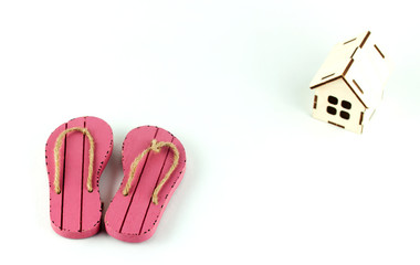 beach flip-flops and wooden house, the concept of falling tourist business
