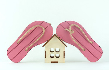 beach flip-flops and wooden house, the concept of falling tourist business