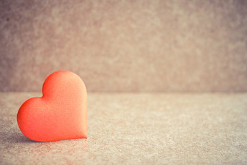 Red heart on the wooden desk background