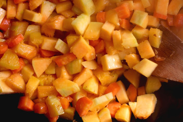 Chopped carrots and butternut squash in a wok. Top view.