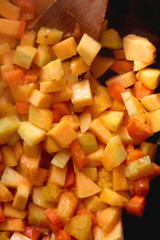 Chopped carrots and butternut squash in a wok. Top view.