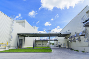 Newly industrial warehouse building with walkway between the building under the blue sky