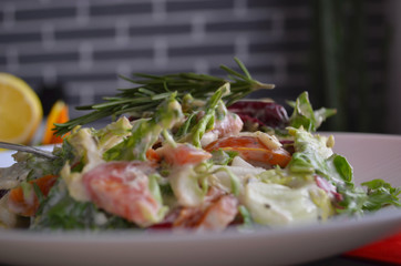 Salad with radishes, lettuce and cherry tomatoes seasoned with diet yogurt. Vitamin spring salad of fresh vegetables. Top view and side view.