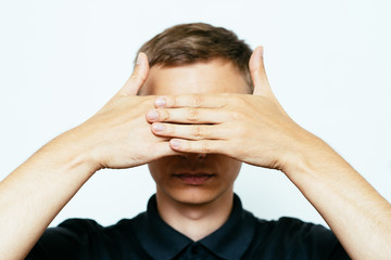 Fototapeta premium Man closes eyes with her hands