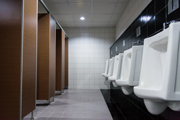 Newly interior toilet room with white urinals in the factory office