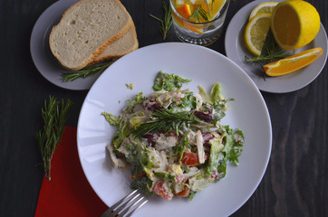 Salad with radishes, lettuce and cherry tomatoes seasoned with diet yogurt. Vitamin spring salad of fresh vegetables. Top view and side view.
