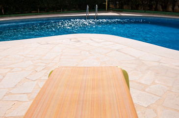 Lonely green hammock in a pool on a sunny day