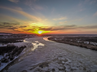 Fototapeta na wymiar beautiful sunset over the spring river opened from ice