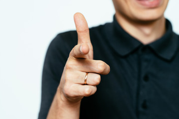 Young man showing his index finger towards the camera