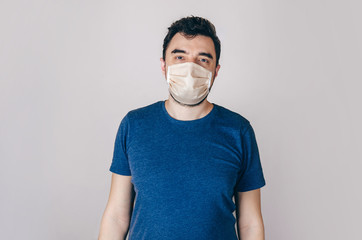 young man wearing a protective mask on light background