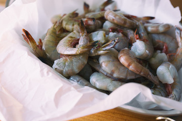 Several pounds of freshly caught Mayport shrimp. Shown in butcher paper, close view. 