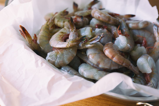 Several pounds of freshly caught Mayport shrimp. Shown in butcher paper, close view. 