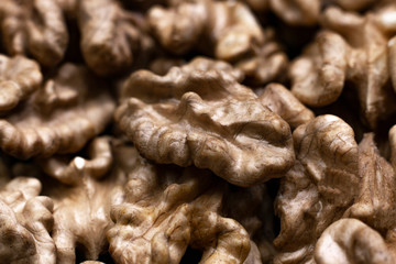 Big walnuts pile close-up. Walnut kernels background. Selective focus.