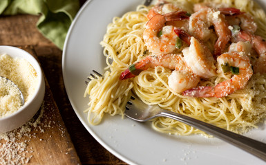 Overhead view of angel hair pasta and shrimp scampi. Close up with fork. 