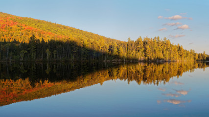 Reflection of autumn trees in lake, Mont-Tremblant National Park, Quebec