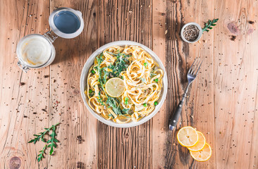 Pasta with a sour cream lemon and herbs on wooden table