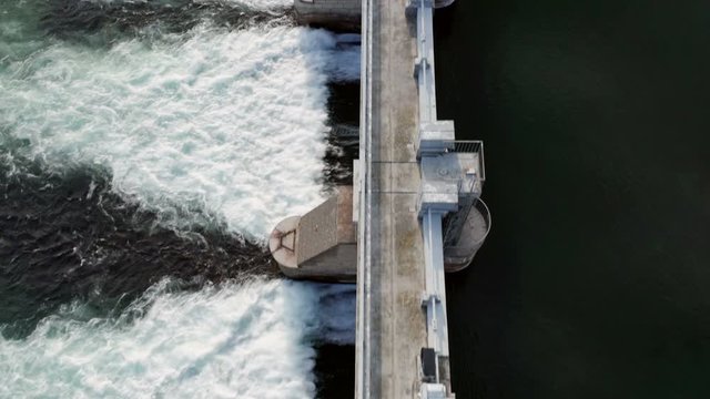 Dam with flowing water at hydroelectric power station located south of Lake Como.