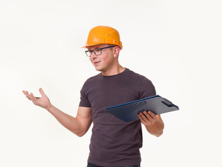 young man - worker in a helmet with a folder