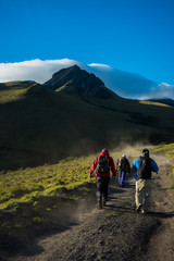 climbers on a rustic road with a mountain and blue sky in the background in ecuador latin america