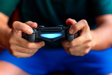 Close-up of a person playing the game console in the quarantine period