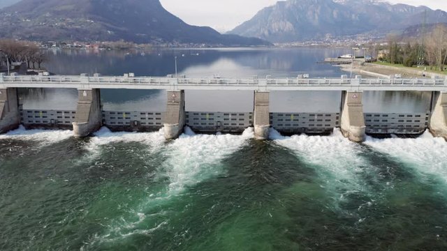 Dam with flowing water at hydroelectric power station located south of Lake Como.