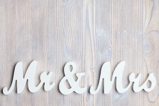 White letters mr and vhk on a wooden background. Top view. Copy space.
