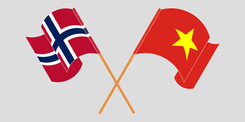 Crossed and waving flags of Norway and Vietnam