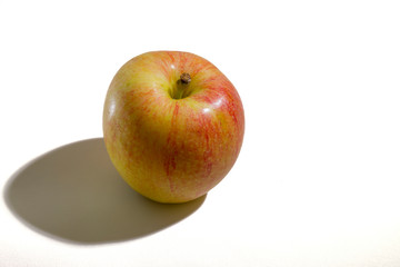The apple is on the table.