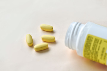 medicines and medicine, box with yellow pills on a beige background