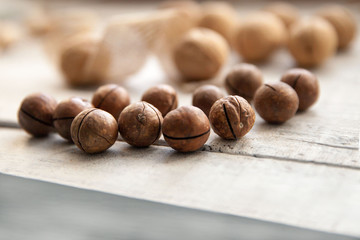 nuts in their shells on a white wooden background