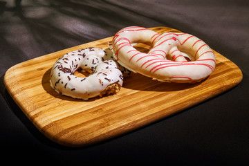 Pretzel cakes are on a wooden Board on the table.