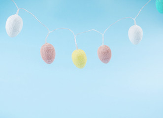 Easter pastel color eggs on blue monochrome background