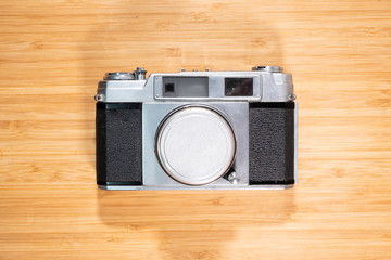 Vintage film camera on wooden table.