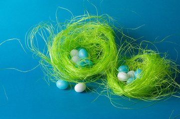 blue and white candy eggs in green nests