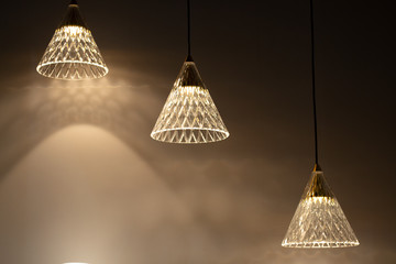 three glass pendant lutres with light