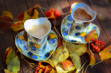 two cups of hot coffee on the table in autumn day