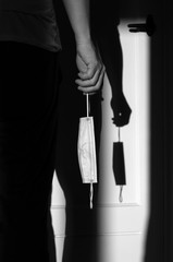 Silhouette of person holding a face mask (concept failed of completed operation))