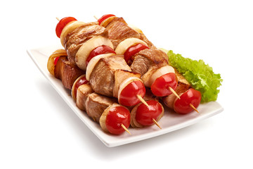 Grilled meat skewers, roasted shish kebab with onion and tomatoes, isolated on white background