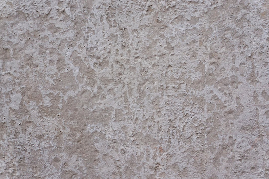 Full frame image of the old weathered beton wall with remnants of old gray paint. High resolution abstract pattern for texture or background, copy-space
