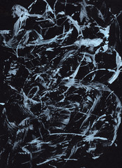 Acrylic hand-drawn background.  Chaotic strokes and spots of white paint on a black background