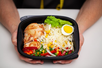 Closeup of a man holding a box full of protein rich foods for sports nutrition