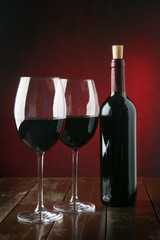 Bottle and glasses with red wine