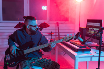 Professional musician recording guitar in digital studio at home, Music production technology...