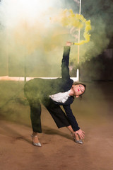 Pasadoble, latin solo dance and contemporary dance - Young beautiful female dancing into smoke cloud