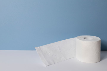 Roll of toilet paper on a blue background.